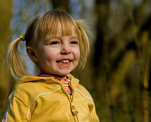 Image showing Little girl looks at a sunset