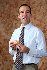Image showing Businessman Having Orange For Snack