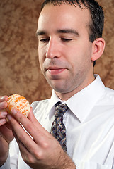 Image showing Businessman Holding Orange