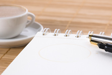 Image showing pen, notebook and cup of coffee