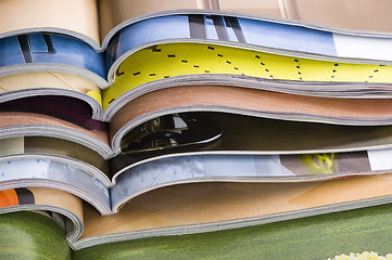 Image showing Stack of open magazines