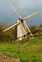 Image showing Old windmill and wooden fence