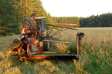 Image showing man operates an old tractor