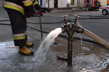 Image showing Hydrant and fireman