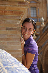 Image showing Young girl smiling and hiding