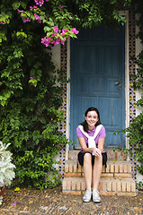 Image showing Young girl sitting on steps