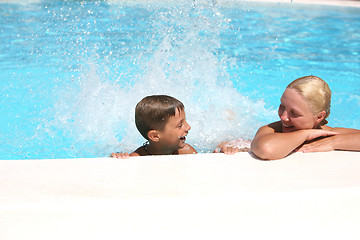 Image showing son and mom swim and play in the pool