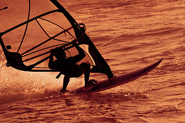 Image showing Surfer on the waves in  sunset