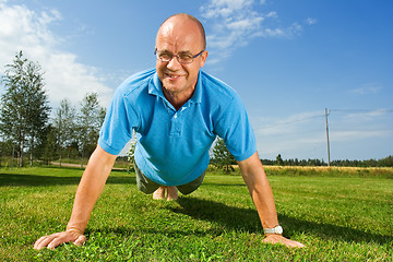 Image showing Older man doing push-ups