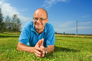 Image showing Middle-aged man smiling on a grass