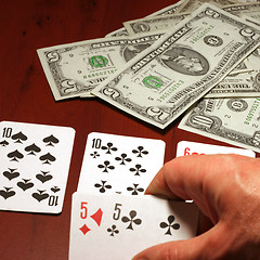 Image showing hand of the person with card for poker and rate in dollars