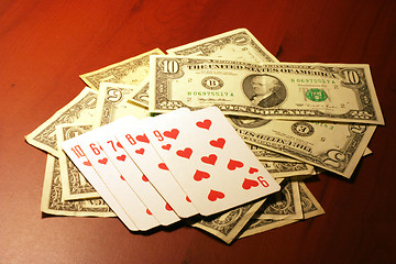 Image showing playing combination in poker and money for rate on table