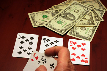 Image showing hand of the person with card for poker and rate in dollars