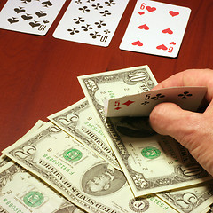 Image showing hand of the person with card for poker and rate in dollars