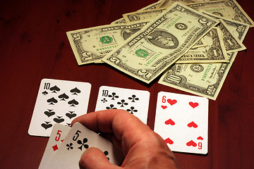 Image showing hand of the person with card for poker and rate in dollars