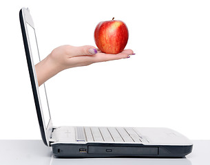 Image showing hand with apple and laptop
