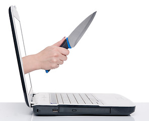 Image showing hand with knife and laptop