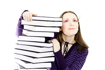 Image showing woman preperaing for exam with toons of books