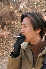 Image showing Asian man smoking