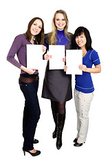 Image showing  Three women holding white paper