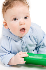 Image showing Baby playing with green plastic block