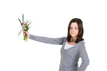 Image showing Woman standing and holding flowers