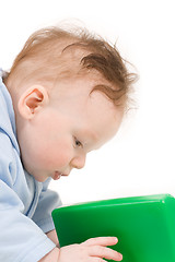 Image showing Baby playing with green plastic block