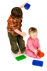 Image showing Two kids playing colorfull blocks