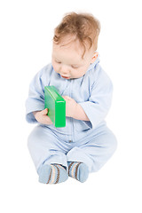 Image showing Baby playing with green plastic block