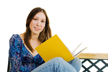 Image showing Woman sitting with yellow book