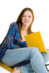 Image showing Woman sitting with yellow book