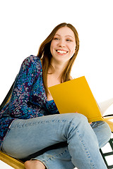 Image showing Woman sitting with yellow book