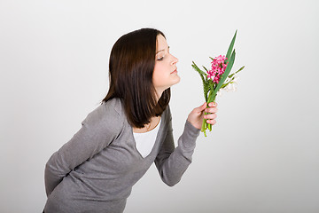 Image showing Woman standing and holding  bouquet 