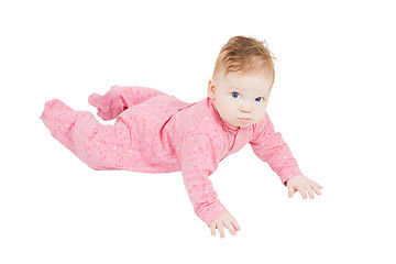 Image showing little boy in ping pyjamas creeping on the floor