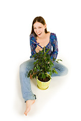 Image showing Woman on the floor cutting plant