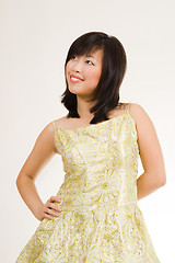Image showing Cute asian women in gold evening dress