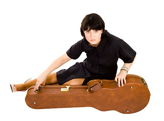 Image showing Woman sitting with guitar case