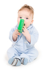 Image showing Baby playing with green plastic block