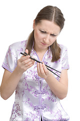 Image showing Woman with chopsticks for sushi