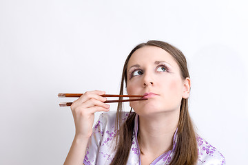Image showing Woman with chopsticks for sushi