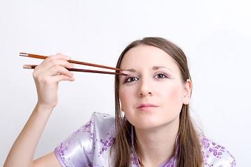 Image showing Woman with chopsticks for sushi