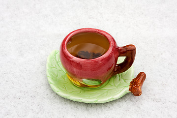 Image showing A cup of tea on a snowy background