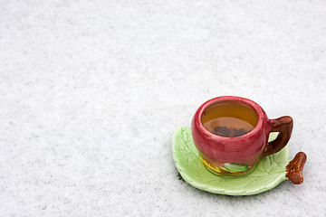 Image showing A cup of tea is on the snow