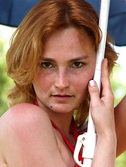 Image showing Girl with the dark-blue beach umbrella