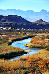 Image showing Image of winding stream in front of mountains