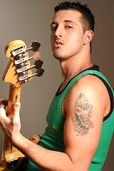 Image showing bass player with tattoo