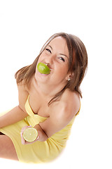 Image showing happy model eating a Lemon