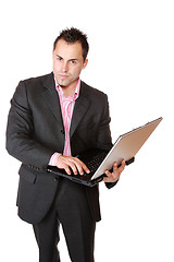 Image showing Happy businessman holding laptop computer