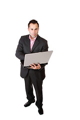 Image showing Happy businessman holding laptop computer