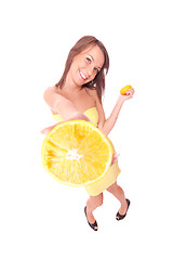 Image showing happy model eating an orange